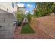 Landscaped side yard with artificial turf and rock at 2236 Alanhurst Dr, Henderson, NV 89052