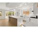 Modern kitchen with white cabinets, large island, and luxury vinyl flooring at 2820 Lotus Hill Dr, Las Vegas, NV 89134