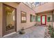 Cozy courtyard entrance showcasing brick pavers, potted plants, and bedroom access at 284 Crimson Edge St, Henderson, NV 89012