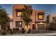 Beautiful shot of a two-story home featuring modern design, a red front door, a two-car garage and appealing landscaping at 284 Crimson Edge St, Henderson, NV 89012