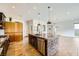 Elegant kitchen featuring a large center island with seating and views into the open concept living area at 284 Crimson Edge St, Henderson, NV 89012