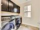 Laundry room with washer, dryer, and cabinets at 284 Crimson Edge St, Henderson, NV 89012