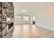 Modern living room features a stone accent wall with a fireplace and sleek flooring at 284 Crimson Edge St, Henderson, NV 89012