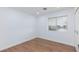 Simple bedroom with wood floors and a window at 3025 Holmes St, North Las Vegas, NV 89030