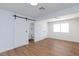 Bright bedroom with barn door and wood floors at 3025 Holmes St, North Las Vegas, NV 89030