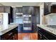 Modern kitchen with dark wood cabinets and granite countertops at 316 Pleasant Summit Dr, Henderson, NV 89012