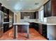 Modern kitchen with dark cabinets, granite counters and island at 316 Pleasant Summit Dr, Henderson, NV 89012