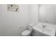 A compact powder room features a modern sink, white toilet, and neutral walls, designed for guest convenience at 334 Taylor St, Henderson, NV 89015