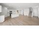 Spacious living room with hardwood floors, white walls, and a modern kitchen area. Lots of natural light at 334 Taylor St, Henderson, NV 89015