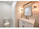 Modern powder room with white vanity, quartz countertop, and black matte fixtures at 336 Merit Ct, Henderson, NV 89014