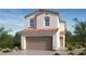 Two-story house with Spanish-style architecture, tile roof, and two-car garage at 334 Taylor St, Henderson, NV 89015