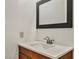 Simple bathroom with wood vanity and a clean white sink at 3817 Bach Way, North Las Vegas, NV 89032