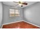 Bedroom with wood flooring and ceiling fan at 3817 Bach Way, North Las Vegas, NV 89032