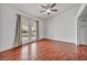 Bedroom with wood floors, ceiling fan, and access to patio at 3817 Bach Way, North Las Vegas, NV 89032