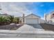 Single story house with attached garage and palm trees at 3817 Bach Way, North Las Vegas, NV 89032