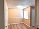 Bedroom with wood-look floors and window at 4348 Tara Ave # 2, Las Vegas, NV 89102