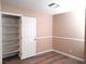 Bedroom with wood-look floors, neutral walls, and closet at 4348 Tara Ave # 2, Las Vegas, NV 89102