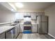 Modern kitchen with stainless steel appliances and wood-look flooring at 4348 Tara Ave # 2, Las Vegas, NV 89102