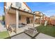 Covered patio, grassy yard, playset, and seating area at 6301 Beavertail Pond Ave, Las Vegas, NV 89122