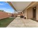 Covered patio with seating area and grassy backyard at 6301 Beavertail Pond Ave, Las Vegas, NV 89122