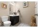 Small bathroom with dark vanity and white toilet at 6301 Beavertail Pond Ave, Las Vegas, NV 89122
