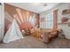 Bedroom with a crib and a playful sun wall mural at 6301 Beavertail Pond Ave, Las Vegas, NV 89122