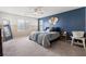 Bright bedroom with a large bed and blue accent wall at 6301 Beavertail Pond Ave, Las Vegas, NV 89122