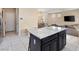 Open kitchen with granite island and dark cabinetry at 6301 Beavertail Pond Ave, Las Vegas, NV 89122