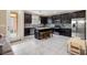 Kitchen with dark cabinetry, granite island, and stainless steel appliances at 6301 Beavertail Pond Ave, Las Vegas, NV 89122