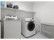 Laundry room with washer, dryer, and shelving at 6301 Beavertail Pond Ave, Las Vegas, NV 89122