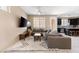 Spacious living room with sectional sofa and kitchen views at 6301 Beavertail Pond Ave, Las Vegas, NV 89122