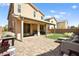 Large backyard with covered patio, artificial turf, and grill at 6389 Jacobville Ct, Las Vegas, NV 89122