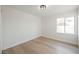 Spacious bedroom with large window and light hardwood floors at 6436 Heatherton Ave, Las Vegas, NV 89110