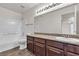 Bathroom with granite countertop, dark brown vanity, and bathtub at 6800 E Lake Mead Blvd # 2028, Las Vegas, NV 89156