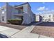 Gray two-story building with walkway, landscaping, and adjacent building visible at 6800 E Lake Mead Blvd # 2028, Las Vegas, NV 89156