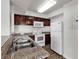 Well-equipped kitchen with granite countertops and dark wood cabinets at 6800 E Lake Mead Blvd # 2028, Las Vegas, NV 89156
