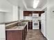 Updated kitchen with granite counters, dark cabinetry, and stainless steel sink at 6800 E Lake Mead Blvd # 2028, Las Vegas, NV 89156