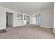 Open living room with neutral walls and carpet flooring, offering views of kitchen at 6800 E Lake Mead Blvd # 2028, Las Vegas, NV 89156