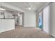 Living room with access to balcony and kitchen, featuring neutral decor and carpet at 6800 E Lake Mead Blvd # 2028, Las Vegas, NV 89156