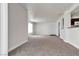 Open living room with kitchen access and an entry door, showcasing neutral tones at 6800 E Lake Mead Blvd # 2028, Las Vegas, NV 89156