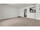 Living room with entryway and kitchen access, featuring neutral colors and carpet at 6800 E Lake Mead Blvd # 2028, Las Vegas, NV 89156