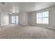 Bright living room featuring carpet, large windows, and a ceiling fan at 6800 E Lake Mead Blvd # 2028, Las Vegas, NV 89156