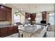 Kitchen with granite countertops and dark wood cabinets at 6861 Philharmonic Ave, Las Vegas, NV 89139