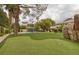 Landscaped backyard with putting green and play area at 105 Quail Run Rd, Henderson, NV 89014