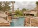 Stunning pool with a rock waterfall feature at 105 Quail Run Rd, Henderson, NV 89014