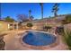 Inviting kidney-shaped pool with waterfall feature in a beautifully landscaped backyard at 1183 Winnipeg Ct, Henderson, NV 89002