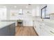 Modern kitchen with white cabinets, quartz countertops, and stainless steel appliances at 1313 Bonita Ave, Las Vegas, NV 89104