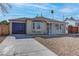 Home exterior showcasing a large driveway and bay window at 1504 E Ogden Ave, Las Vegas, NV 89101