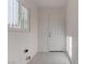 Laundry room with window, door, and tile floor at 1504 E Ogden Ave, Las Vegas, NV 89101