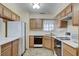 Full kitchen with oak cabinets, microwave, and stove at 1665 Rowan Tree Dr, Las Vegas, NV 89123